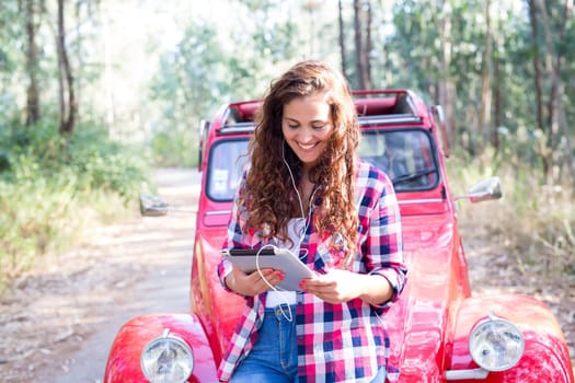Young woman resting at car trip by the countryside