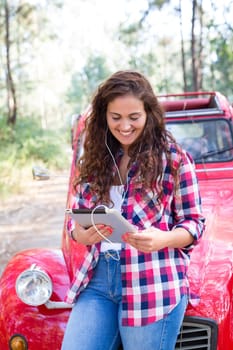 Young woman resting at car trip by the countryside