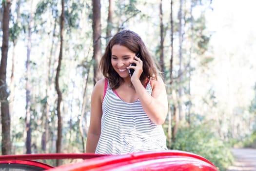 Young woman resting at car trip by the countryside