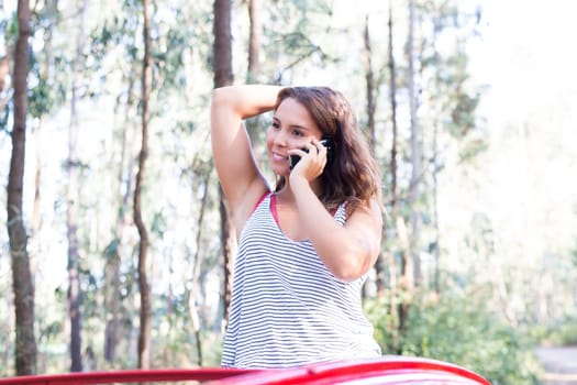 Young woman resting at car trip by the countryside