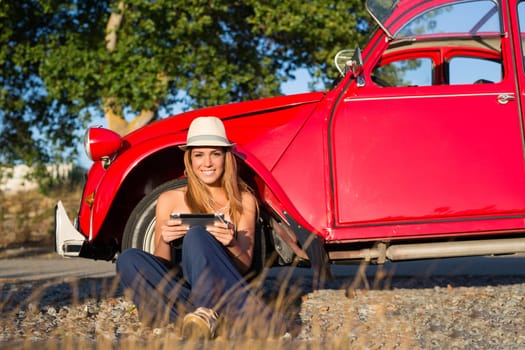 Young woman resting at car trip by the countryside