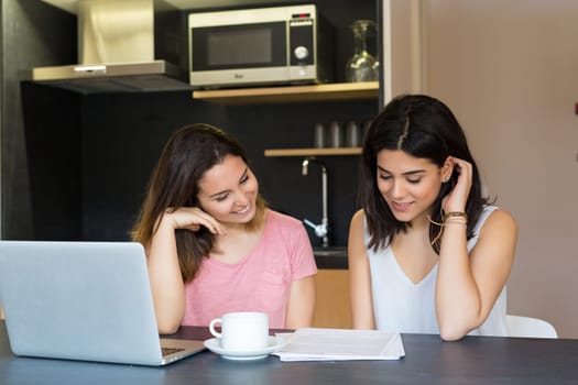 Beautiful young women at home studying for the final exams