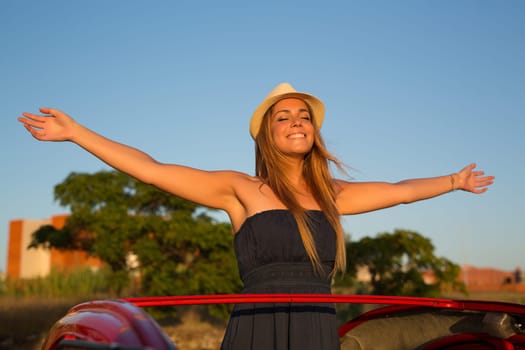Woman going on a roadtrip in her convertible car