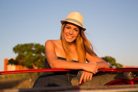 Woman going on a roadtrip in her convertible car