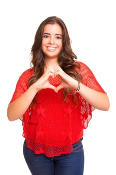 Beautiful woman making a heart shape with her hands, isolated over white background