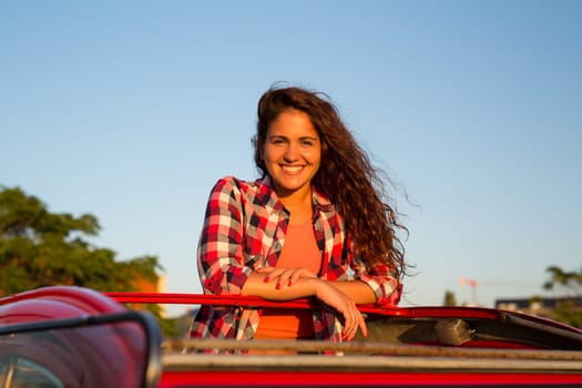Woman going on a roadtrip in her convertible car
