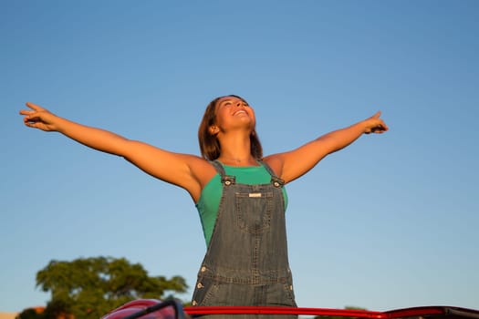Woman going on a roadtrip in her convertible car