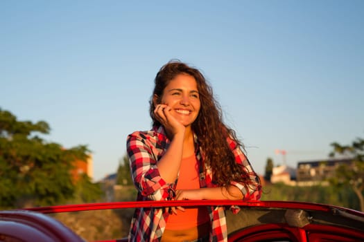 Woman going on a roadtrip in her convertible car