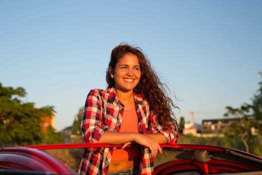 Woman going on a roadtrip in her convertible car