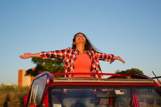 Woman going on a roadtrip in her convertible car