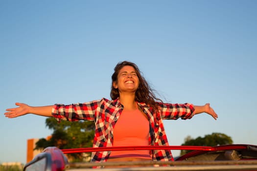 Woman going on a roadtrip in her convertible car