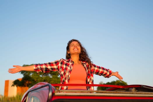 Woman going on a roadtrip in her convertible car