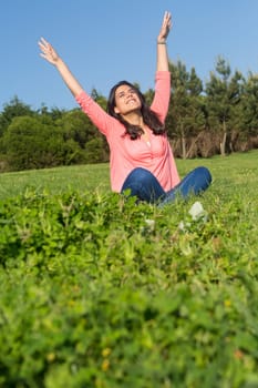A beautiful young woman relaxing at the city park
