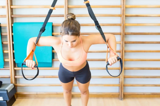 Young woman getting into shape at the gym