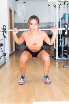 Young woman getting into shape with one more training session