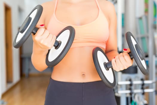 Young woman getting into shape at the gym