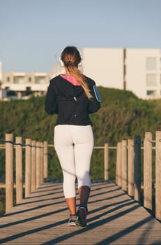 Young beautiful chinese woman exercising at the beach at sunrise/sunset