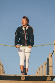 Young beautiful chinese woman exercising at the beach at sunrise/sunset