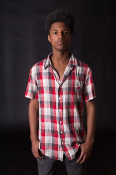 A casual young black boy posing isolated