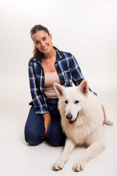 Young woman playing with her dog at the studio