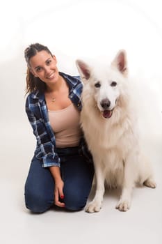 Young woman playing with her dog at the studio