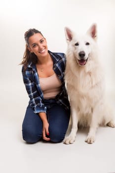 Young woman playing with her dog at the studio