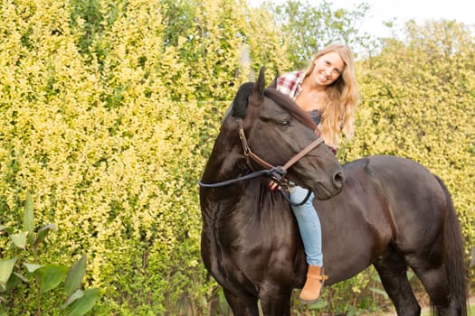 Beautiful and natural young woman spending sometime with her horse