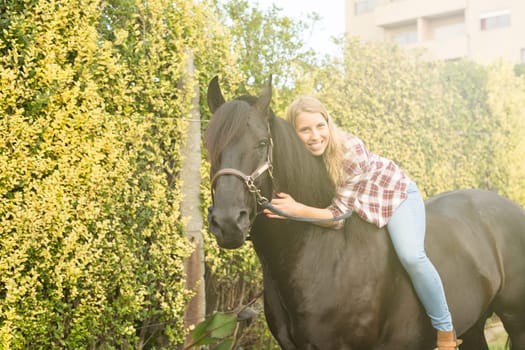 Beautiful and natural young woman spending sometime with her horse