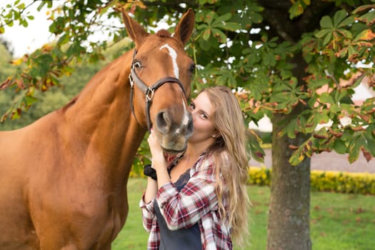 Beautiful and natural young woman spending sometime with her horse