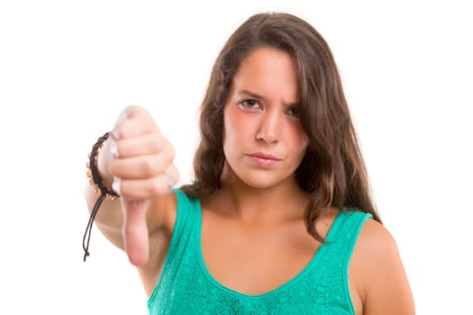 Studio shot of a young woman signaling thumbs down