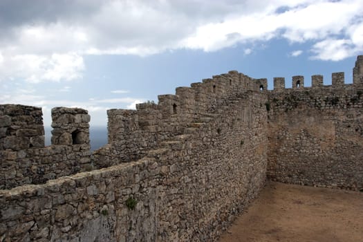 Castle wall perspective, isolated in blue sky background