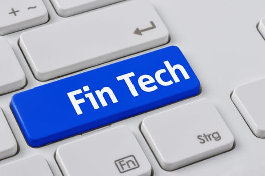 A keyboard with a blue button - Fin Tech