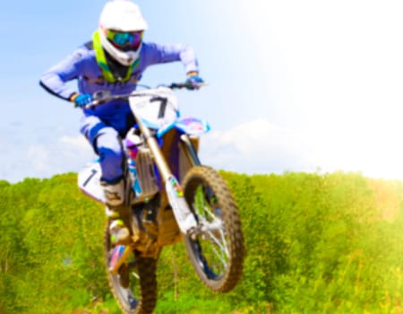 Blurry image of motorcycle rider during motocross race
