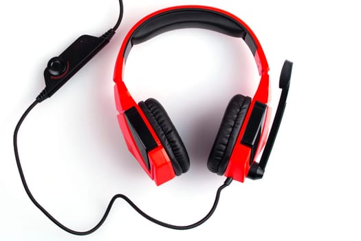 Red headphones with a microphone isolated on white background