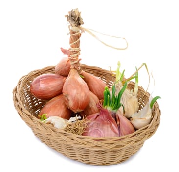 shallots and onions in a basket on the white background