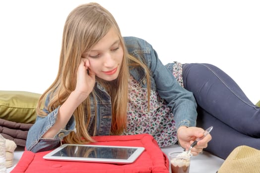 a teenager with a digital tablet eating yogurt