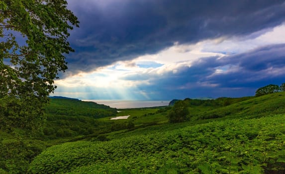 moody and atmospheric image with view of the lake and clouds with sun rays