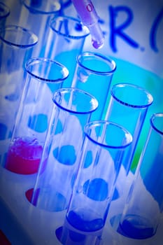 test tubes and flasks with colored liquid in a laboratory