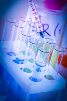 test tubes and flasks with colored liquid in a laboratory