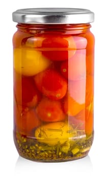 Pickled red and yellow tomato in glass isolated on white background.