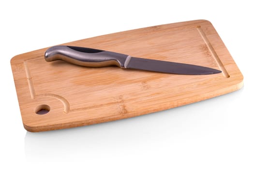 Empty chopping board with a sharp paring knife on white background