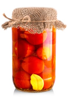 Pickled red and yellow tomato in glass isolated on white background.