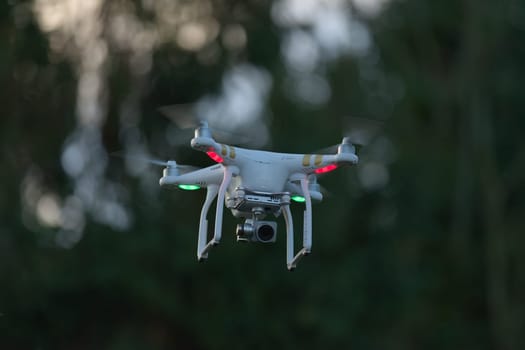 5 - UAV remote control white drone hovers with plain background. Digital camera payload including gimbal stabilisation. Used professionally.