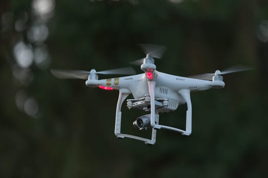 18 - Side view of professional camera drone for videography. 4 sets of propellers as its a quadcopter, controlled by radio link and also by FPV video