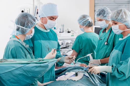Surgeons performing a surgery in an operating room