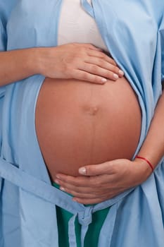 Mid section view of a pregnant woman in a hospital