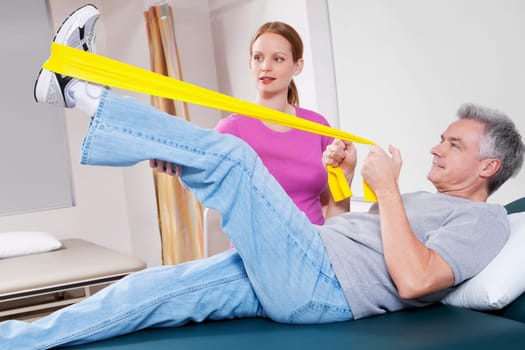 Physiotherapist assisting a patient in exercising