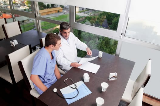 Doctors discussing a medical report in a cafeteria