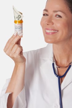 Female doctor holding a pill bottle with currency note