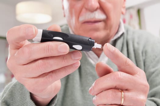 Man testing his blood sugar level